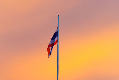 Low angle view of thai flag against sky during sunset