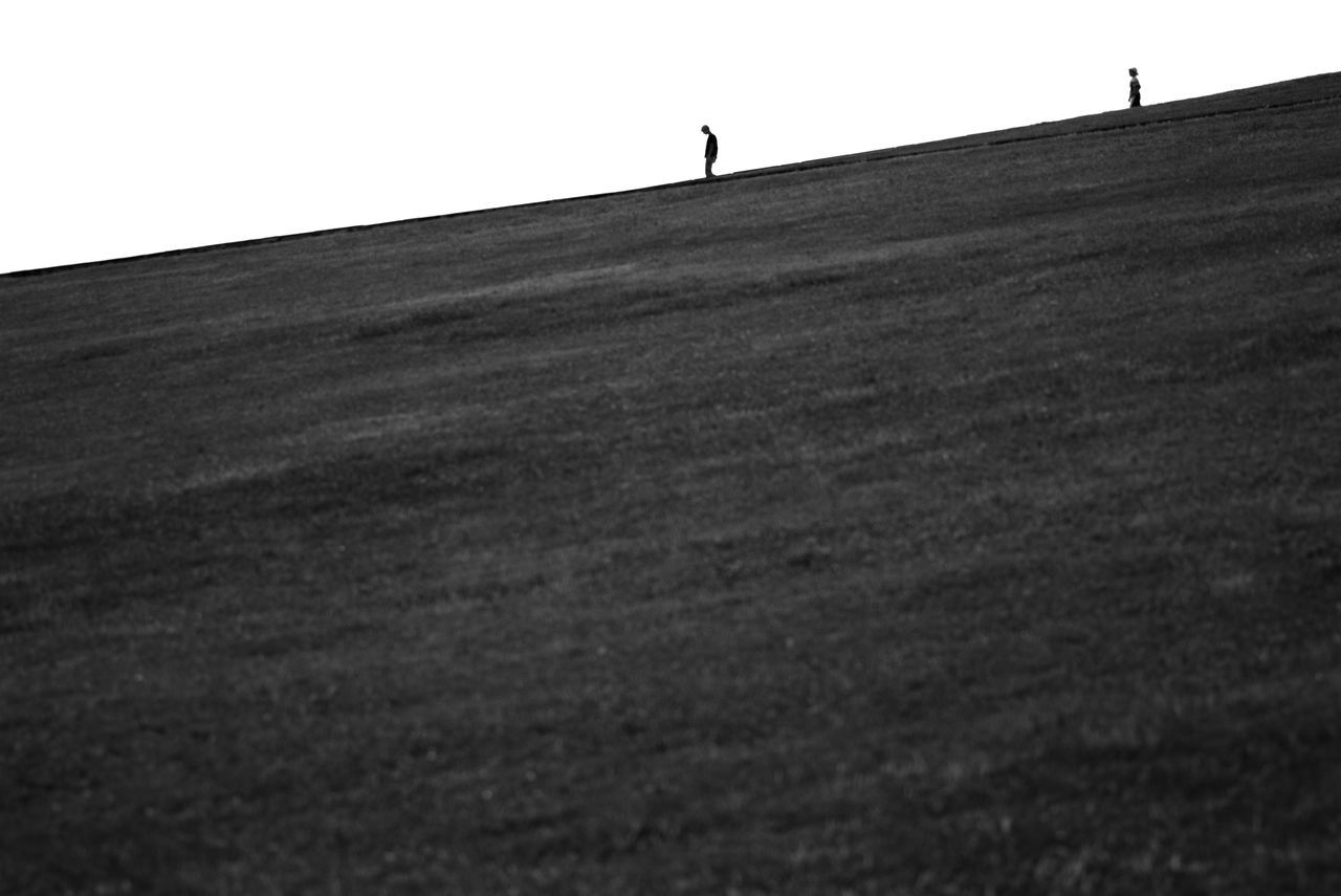 SURFACE LEVEL OF PEOPLE WALKING ON LANDSCAPE