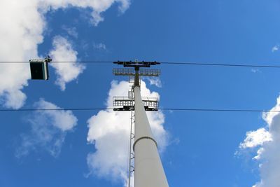 Low angle view of telephone pole against sky