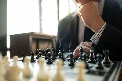 Low angle view of man playing on chess board