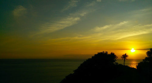 Scenic view of sea against romantic sky at sunset