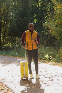 Rear view of man standing in forest