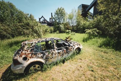 Abandoned car on field