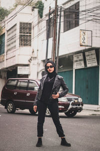 Full length of woman standing on street in city