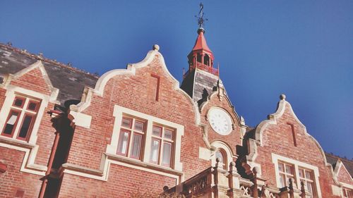 Low angle view of building against clear blue sky