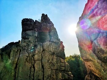 Low angle view of rock formation against sky