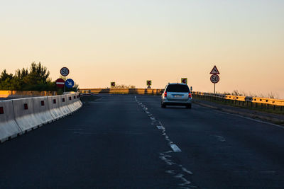 Cars on street against clear sky