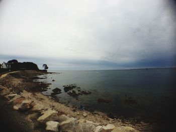 Scenic view of sea against cloudy sky