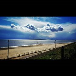 Scenic view of sea against cloudy sky