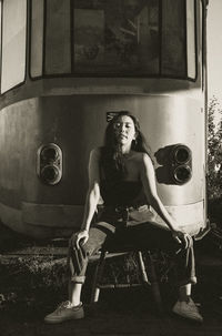 Side view of young woman sitting in train