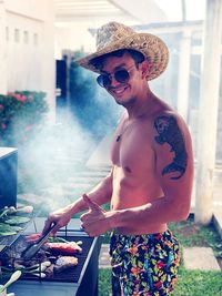 Man wearing hat while preparing food