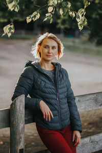 Portrait of young woman sitting outdoors