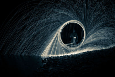 Wire wool against sky at night