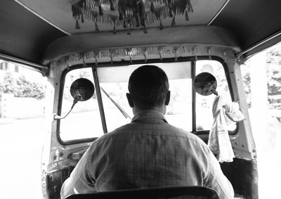 Rear view of people traveling in bus