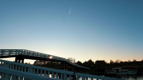 Low angle view of bridge against clear sky during sunset