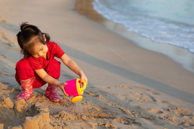 Girl playing with toy on beach