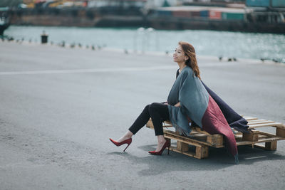 Woman sitting on sand