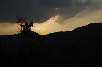 Silhouette trees against sky during sunset