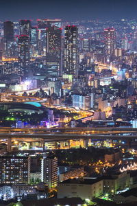 High angle view of city lit up at night