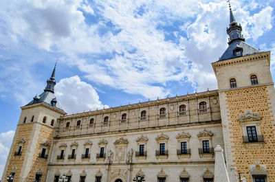 Low angle view of building against cloudy sky