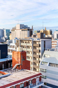 High angle view of buildings in city against sky