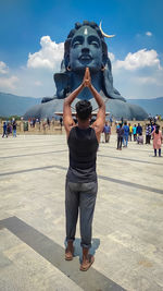 Full length of woman statue against sky in city