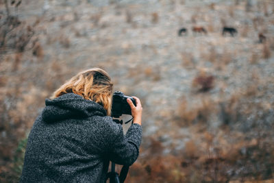 Rear view of woman photographing