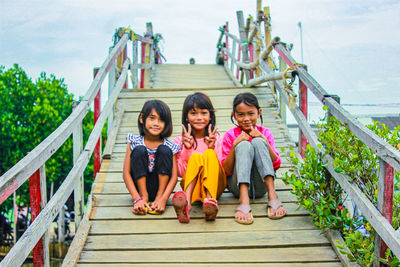Portrait of young woman walking on footbridge