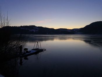 Scenic view of lake against sky at sunset