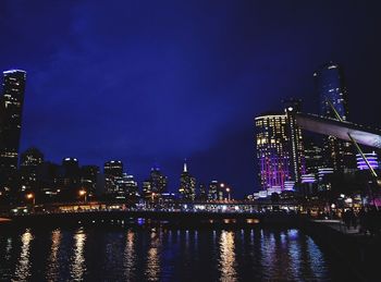 Illuminated city at waterfront