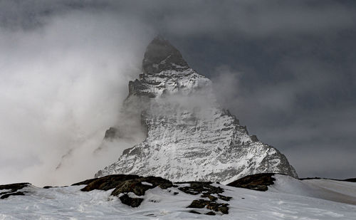 Scenic view of snow covered mountain against sky