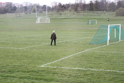 People walking on grassy field
