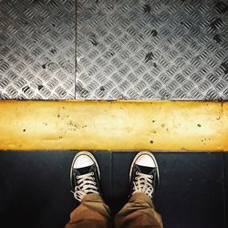 Low section of woman standing on tiled floor