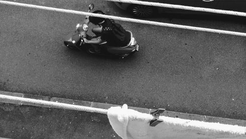 High angle view of man riding motorcycle on road