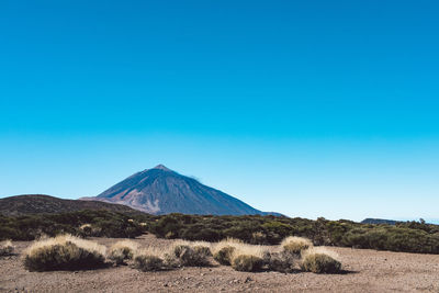 Scenic view of snowcapped mountain against blue sky