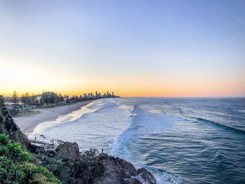 Scenic view of beach against sky during sunset