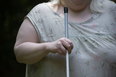 Midsection of woman holding umbrella