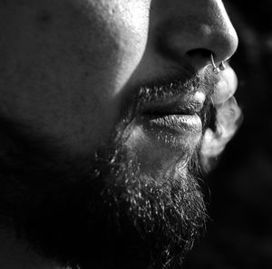 Cropped image of young man against black background