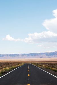 Road passing through landscape against sky