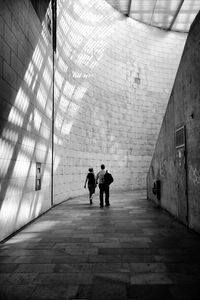 Men walking in corridor
