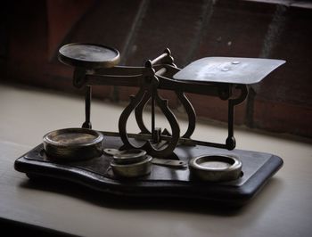 Close-up of antique weight scale on table