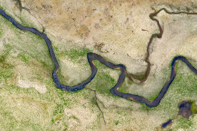 Aerial view of river flowing on landscape
