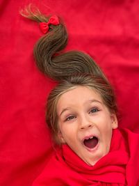 Blond girl happy and excited about christmas and new year with a christmas tree hairdo