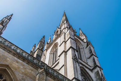 Low angle view of temple building against blue sky