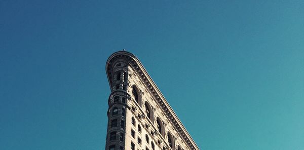 Low angle view of building against clear blue sky