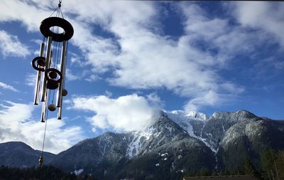 Low angle view of snowcapped mountains against sky