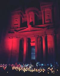 Crowd at illuminated temple at night