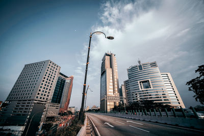 Street amidst buildings against sky in city