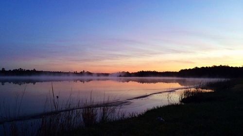 Scenic view of lake at sunset