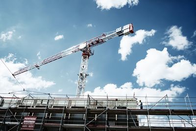 Low angle view of crane against sky